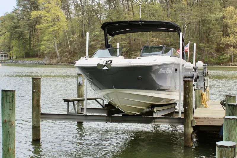 Slide: The Image of 2018 Sea Ray SDX 290 Outboard on a boat lift by the lake. - 10