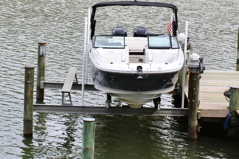 Slide: The Image of 2018 Sea Ray SDX 290 Outboard on boat lift at dock. - 11