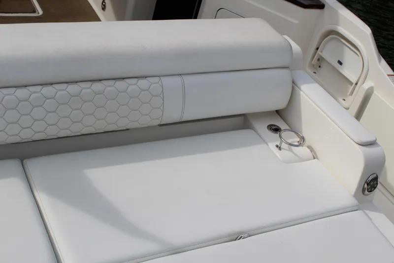 Slide: The Image of 2018 Sea Ray SDX 290 Outboard seating area with white upholstery. - 17