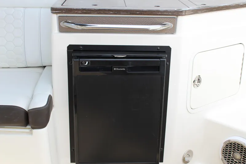 Slide: The Image of 2018 Sea Ray SDX 290 Outboard refrigerator and seating area. - 25