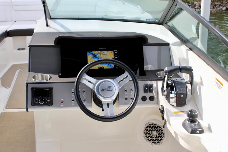 Slide: The Image of 2018 Sea Ray SDX 290 Outboard cockpit with steering wheel and navigation system. - 35