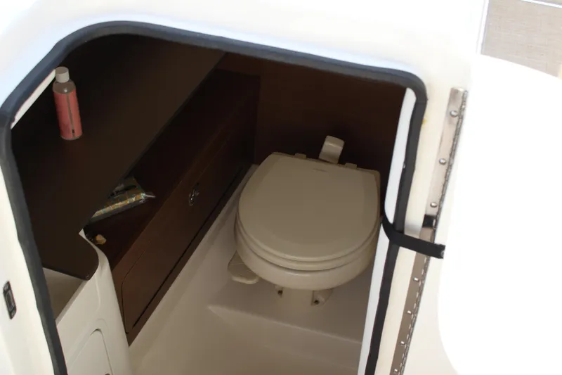 Slide: The Image of Interior of 2018 Sea Ray SDX 290 Outboard featuring a toilet. - 47