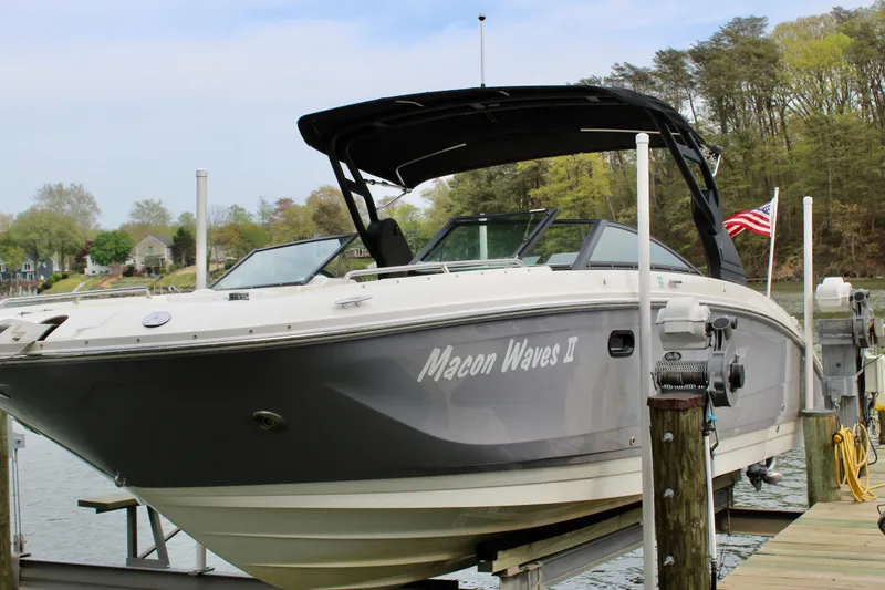 The Image of 2018 Sea Ray SDX 290 Outboard boat docked with US flag. - 8