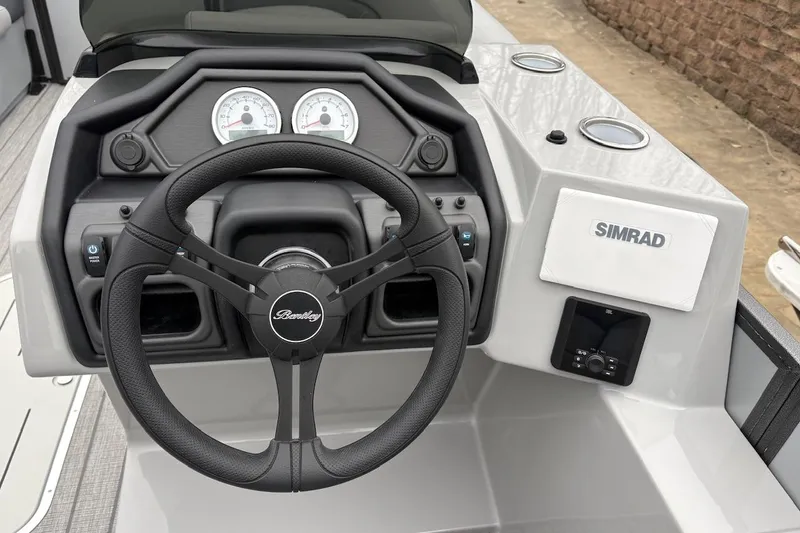Slide: The Image of 2026 Bentley Pontoons Legacy 223 Navigator dashboard with steering wheel and Simrad display. - 10