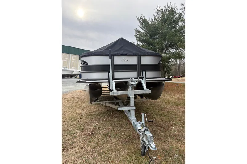 Slide: The Image of 2026 Bentley Pontoons Legacy 223 Navigator on trailer, parked outdoors. - 2