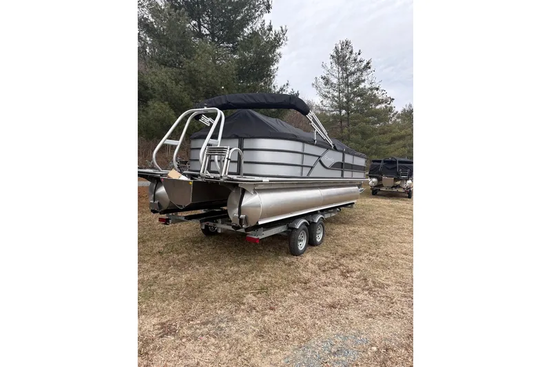 Slide: The Image of 2026 Bentley Pontoons Legacy 223 Navigator on trailer, parked outdoors. - 4