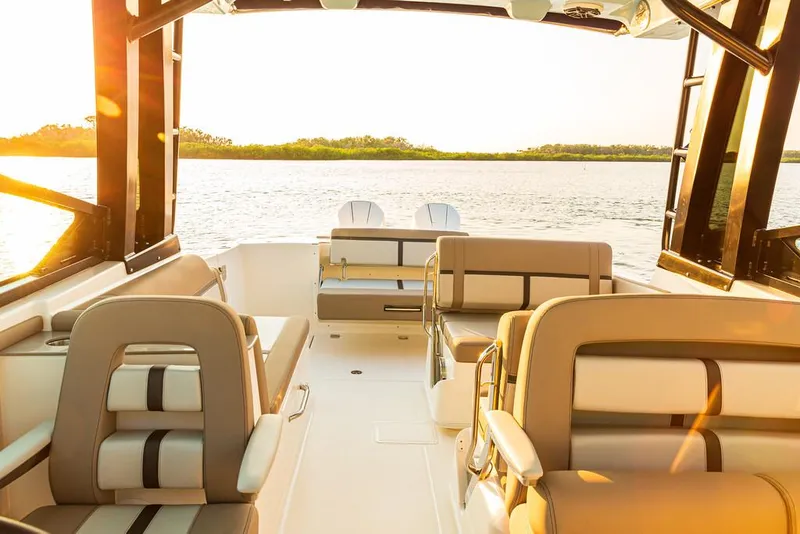 Slide: The Image of Manufacturer Provided Image: 2025 Boston Whaler 330 Vantage interior with luxurious seating, overlooking serene water. - 10