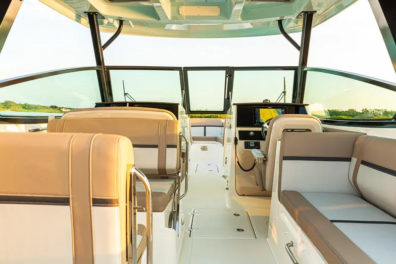 Slide: The Image of Manufacturer Provided Image: Interior of 2025 Boston Whaler 330 Vantage boat, featuring luxurious seating and modern dashboard. - 6