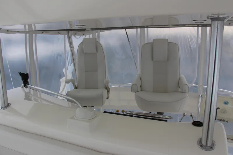 Slide: The Image of Luxury helm seats on a 2000 Post 50 yacht, featuring sleek white design. - 19