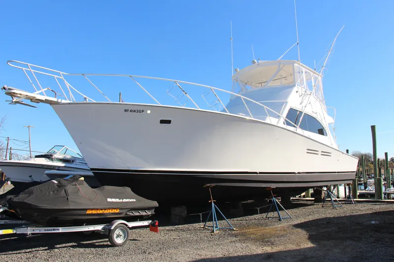 Slide: The Image of 2000 Post 50 yacht on stands, with a covered Sea-Doo jet ski nearby. - 2