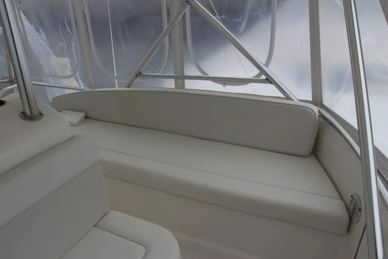 Slide: The Image of Interior of a 2000 Post 50 boat with white seating and clear windows. - 20
