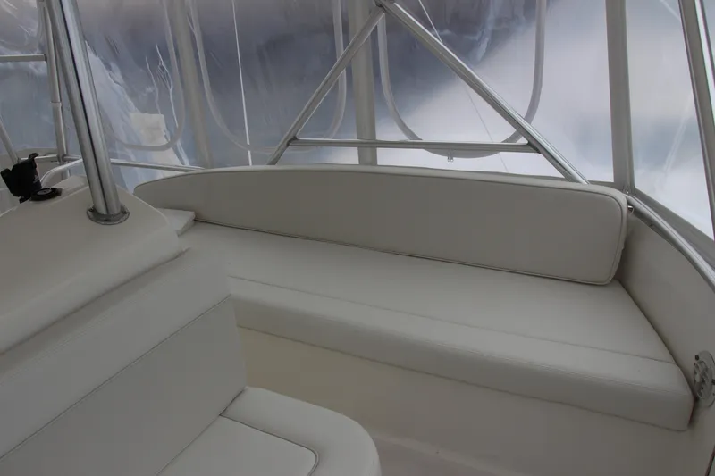 Slide: The Image of Interior of a 2000 Post 50 boat with white seating and clear windows. - 21