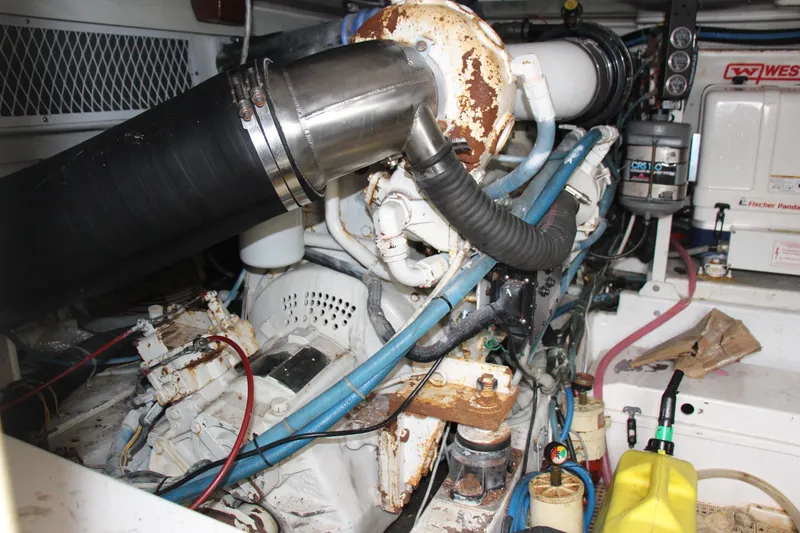 Slide: The Image of Engine room of a 2000 Post 50 boat, showing complex machinery and piping. - 23