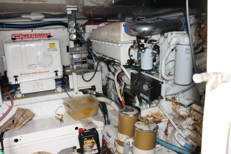 Slide: The Image of Engine room of a 2000 Post 50 yacht with Westerbeke generator and various mechanical components. - 24