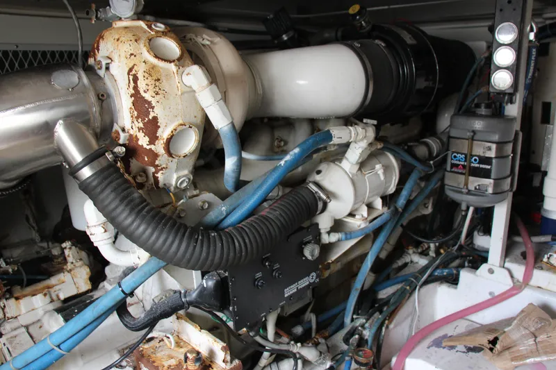 Slide: The Image of Engine room of a 2000 Post 50 yacht, featuring complex piping and machinery. - 26
