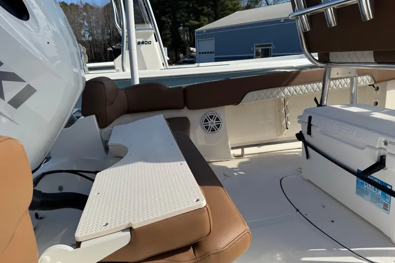 Slide: The Image of 2026 Pioneer 202 Islander boat interior with cushioned seating and Engel cooler. - 6