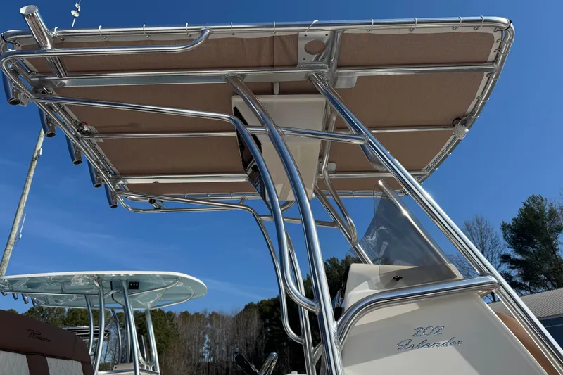 Slide: The Image of 2026 Pioneer 202 Islander boat with T-top against clear blue sky. - 9