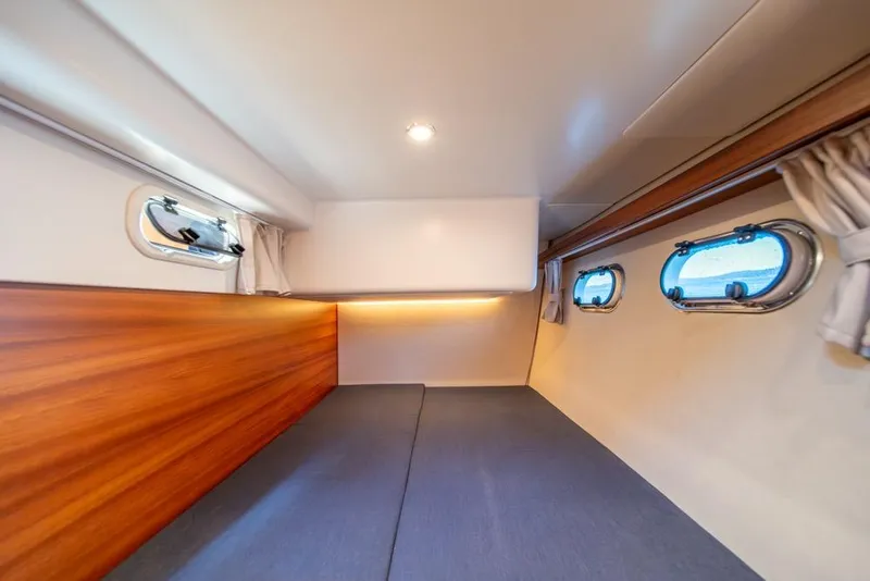 Slide: The Image of Interior cabin of 2022 Nimbus 405 Coupé with wood paneling and porthole windows. - 35