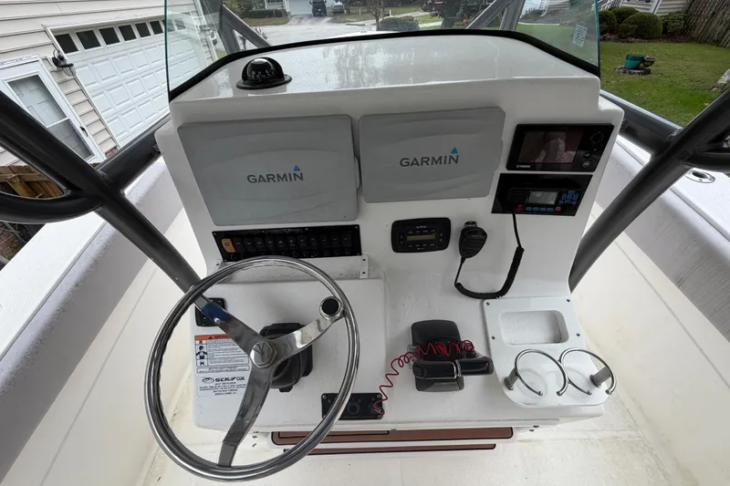 Slide: The Image of 2015 Sea Fox 286 Commander helm with Garmin electronics and steering wheel. - 14