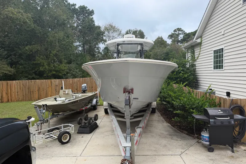 Slide: The Image of 2015 Sea Fox 286 Commander boat on trailer beside a house and grill. - 2