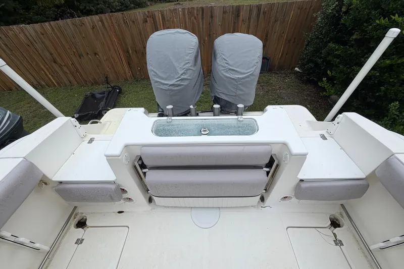 Slide: The Image of 2015 Sea Fox 286 Commander boat deck with covered engines and seating area. - 23