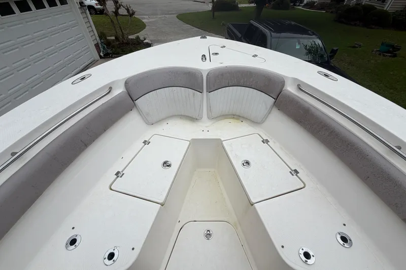 Slide: The Image of 2015 Sea Fox 286 Commander boat interior with cushioned seating and storage compartments. - 7