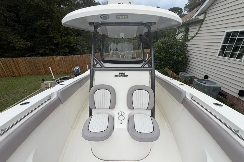 Slide: The Image of 2015 Sea Fox 286 Commander boat with dual seats and center console in a backyard setting. - 8