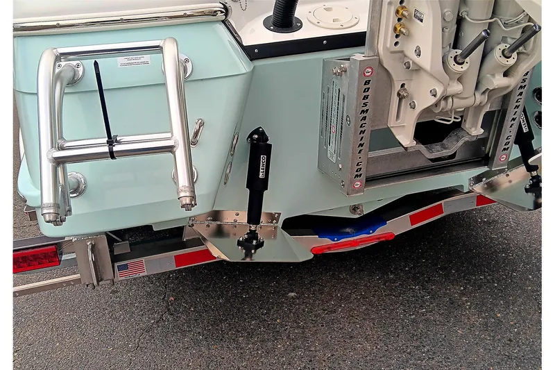 Slide: The Image of 2026 BlackJack 256 Coastal boat transom with ladder and hydraulic components. - 17