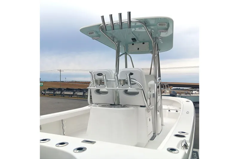 Slide: The Image of 2026 BlackJack 256 Coastal boat with T-top and dual seating, docked outdoors. - 19