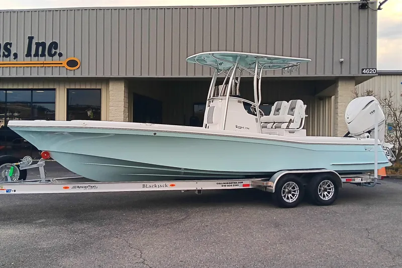 Slide: The Image of 2026 BlackJack 256 Coastal boat on trailer outside a building. - 3