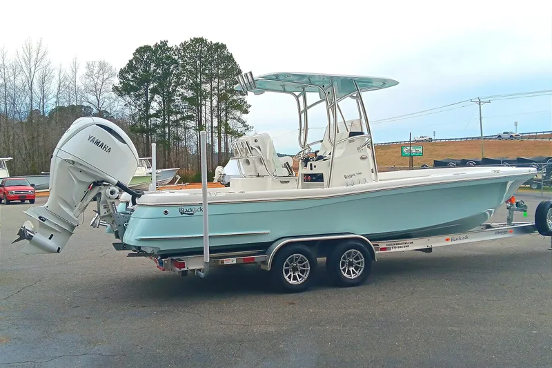 Slide: The Image of 2026 BlackJack 256 Coastal boat on trailer with Yamaha engine, parked outdoors. - 5