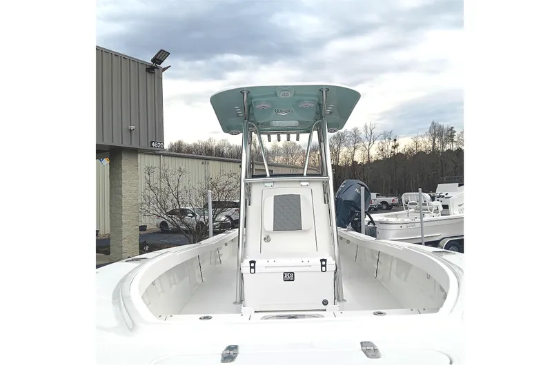 Slide: The Image of 2026 BlackJack 256 Coastal boat, white interior, docked near industrial building. - 7