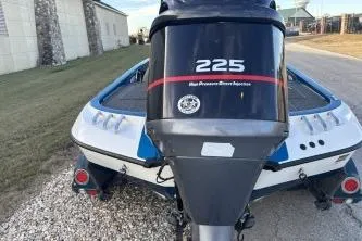 Slide: The Image of 2006 Ranger Z20 boat with 225 horsepower motor, parked on gravel. - 4