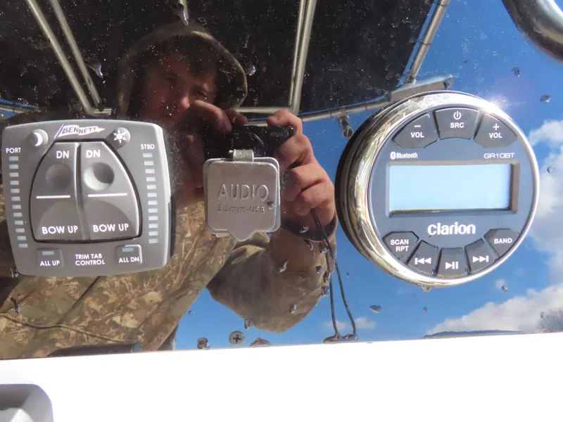 Slide: The Image of Bulls Bay 230 CC controls with Clarion Bluetooth audio and trim tab operation. - 18