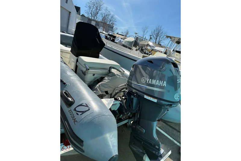 Slide: The Image of 2023 Zodiac Pro Classic 420 with Yamaha outboard motor in a marina setting. - 4