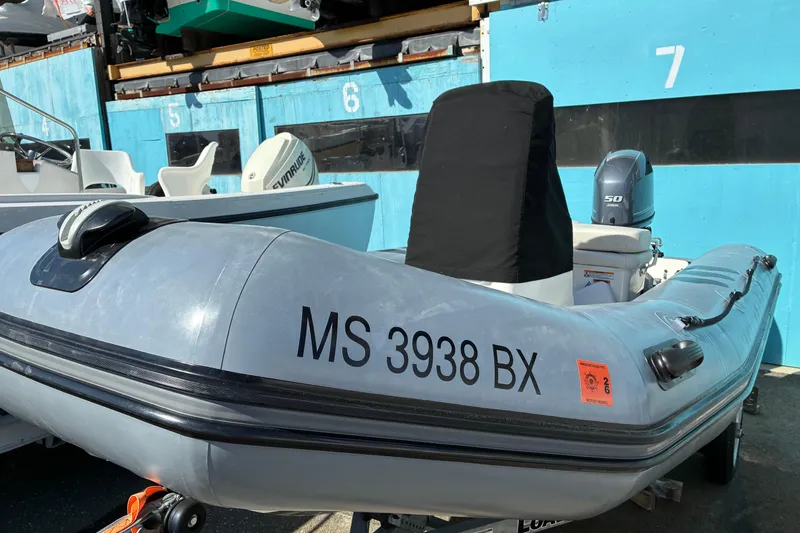 Slide: The Image of 2023 Zodiac Pro Classic 420 inflatable boat docked, featuring registration number MS 3938 BX. - 5