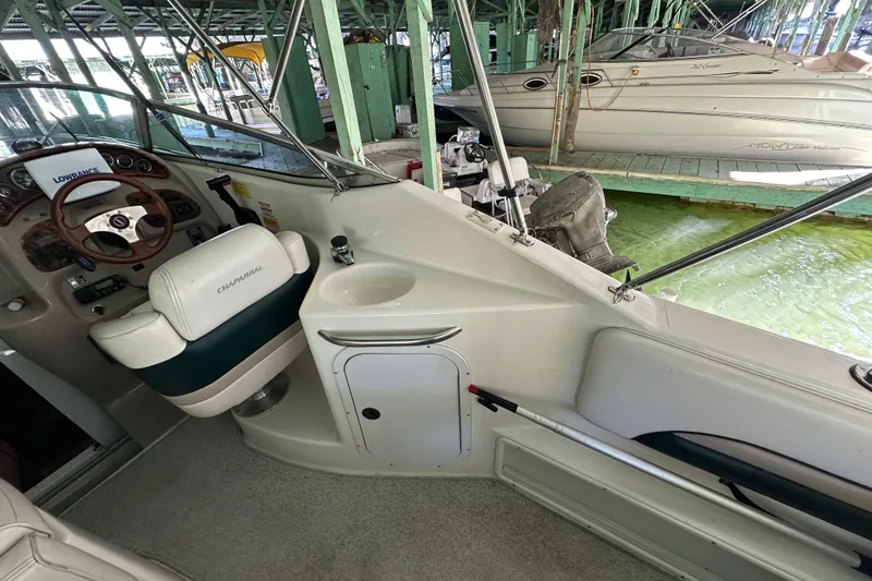 Slide: The Image of 1998 Chaparral Signature 2600 boat interior with steering wheel and seating area. - 10