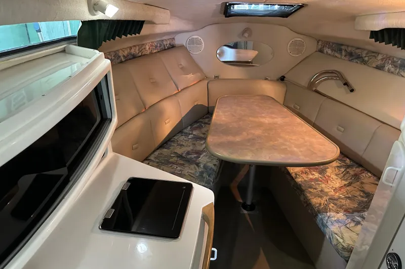 Slide: The Image of 1998 Chaparral Signature 2600 cabin interior with seating and table. - 2