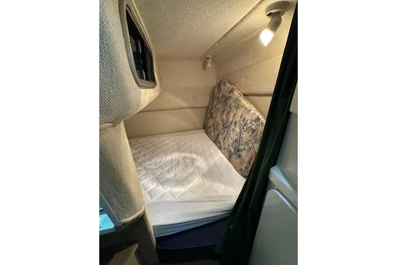 Slide: The Image of 1998 Chaparral Signature 2600 cabin interior with bed and reading light. - 4