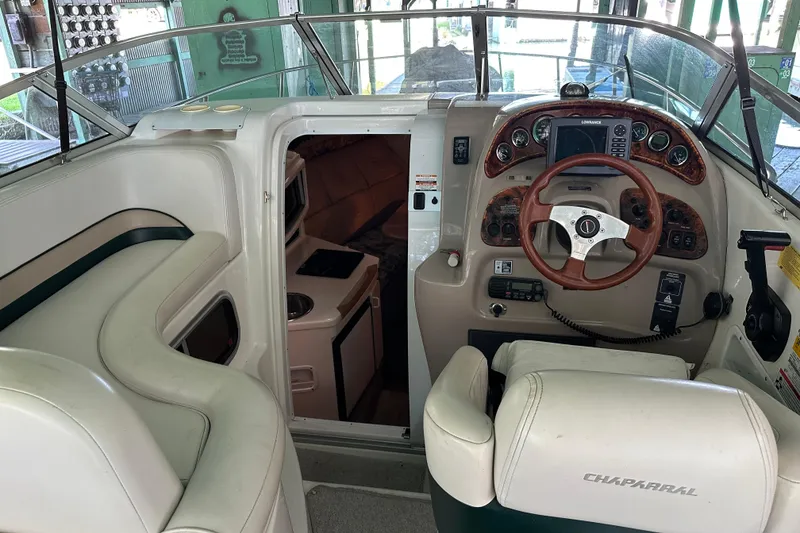 Slide: The Image of 1998 Chaparral Signature 2600 boat interior with helm, seating, and cabin entrance. - 5