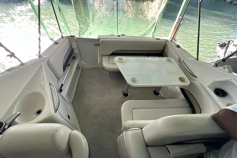 Slide: The Image of 1998 Chaparral Signature 2600 boat interior with seating and table, overlooking water. - 6