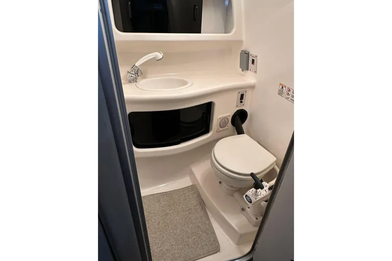 Slide: The Image of 1998 Chaparral Signature 2600 boat bathroom with sink and toilet. - 8