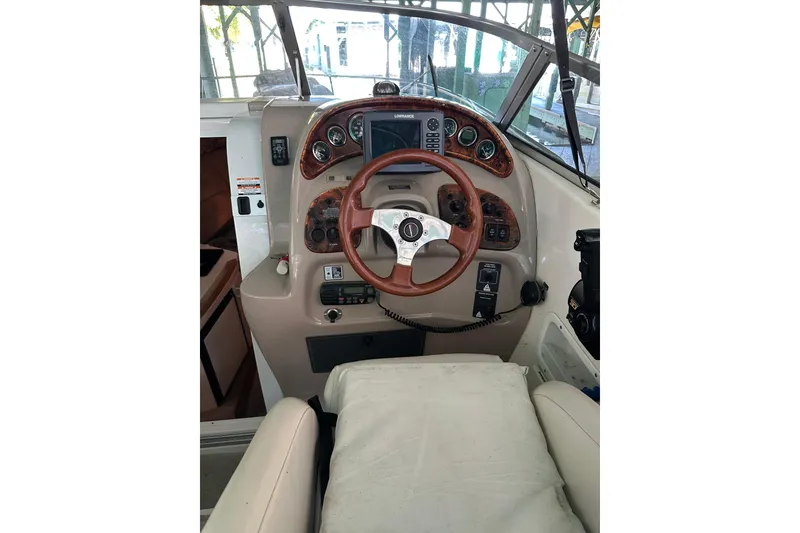 Slide: The Image of 1998 Chaparral Signature 2600 boat dashboard with steering wheel and control panel. - 9