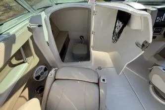 Slide: The Image of 2011 Chaparral 246 SSi boat interior with open storage compartment and seating area. - 7
