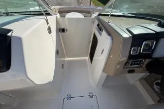 Slide: The Image of 2011 Chaparral 246 SSi boat with beige leather seating and shadowed sunlight. - 8