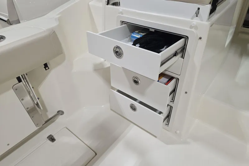 Slide: The Image of 2026 Boston Whaler 285 Conquest interior storage drawers, showcasing organized boat storage solutions. - 10