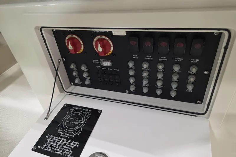 Slide: The Image of Control panel of 2026 Boston Whaler 285 Conquest boat with battery switches and circuit breakers. - 11