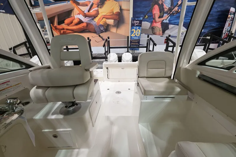 Slide: The Image of 2026 Boston Whaler 285 Conquest interior with white seating and modern design. - 12