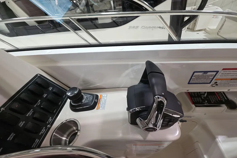 Slide: The Image of Control panel of 2026 Boston Whaler 285 Conquest boat, featuring throttle and switches. - 13