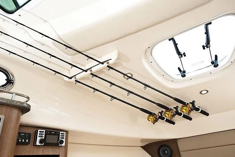 Slide: The Image of Manufacturer Provided Image: Interior of 2026 Boston Whaler 285 Conquest with fishing rods and ceiling hatch. - 2